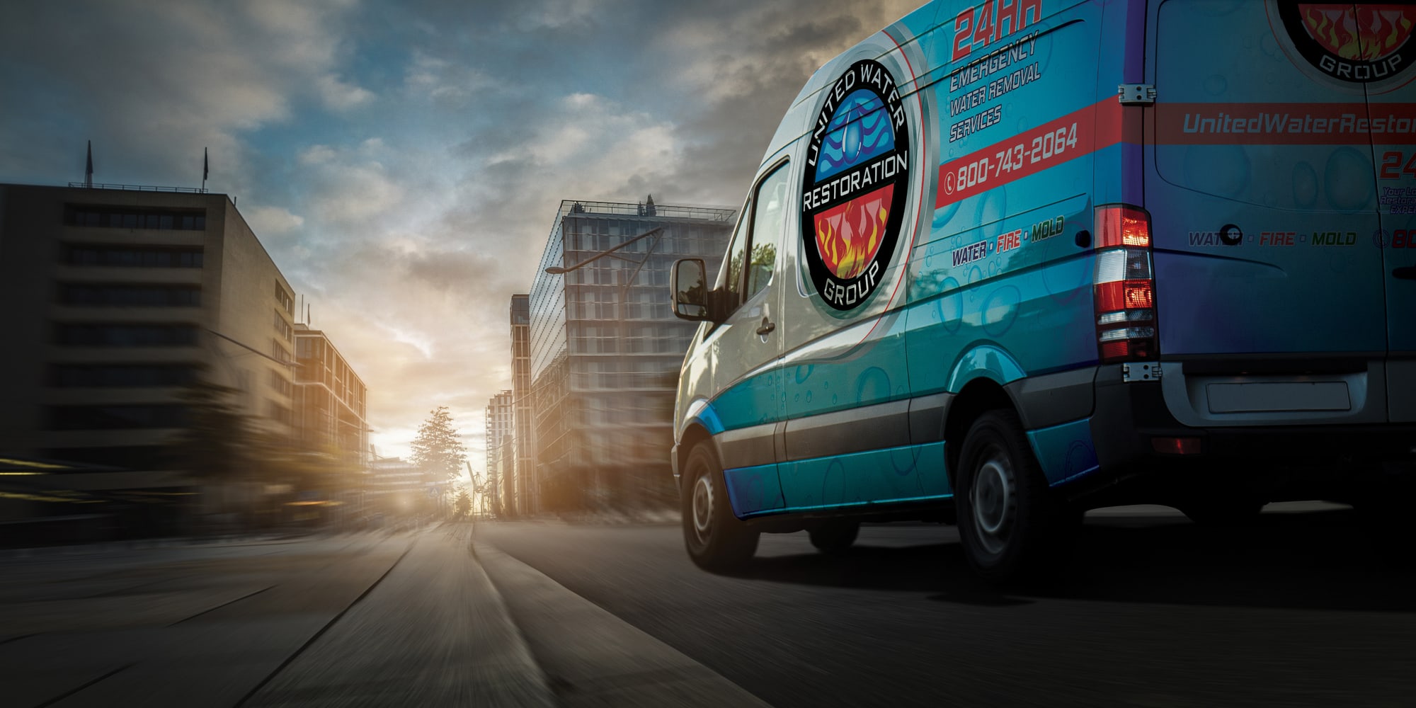 A United Water Restoration Group of San Antonio van heading out on an emergency call at sunset